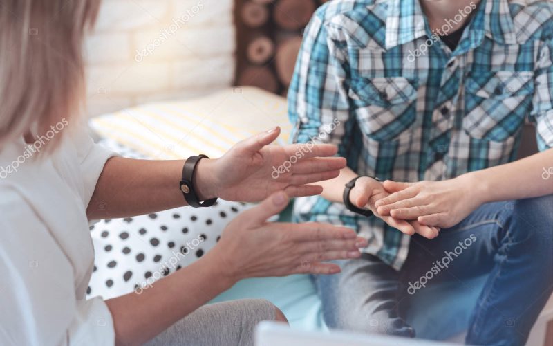 Gesturing while talking. Scaled up shot of a therapeutic process between a professional therapist and a teenage boy in an office.